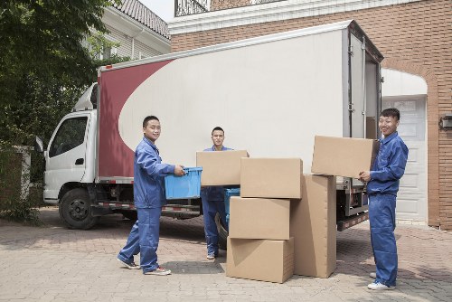 Mover sorting recyclable cardboard and packing materials during a Croydon relocation