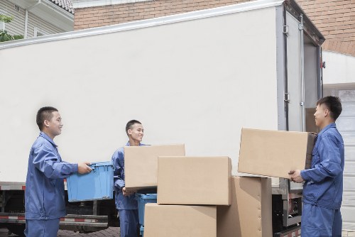Mover carrying furniture through a property entrance